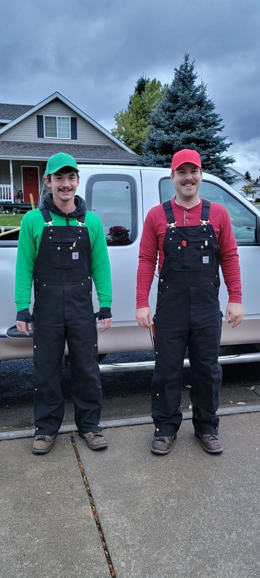 Two members of the Enders team standing in front of a work truck